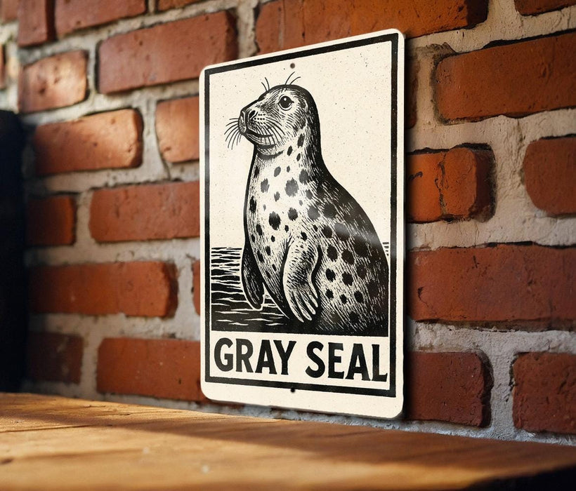A sign featuring a black and white illustration of a gray seal against a brick wall.