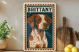 A framed illustration of a dog, specifically a brittany dog, is displayed on a shelf next to a wooden cutting board and some lemons.