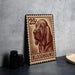 A 25¢ postage stamp featuring a bloodhound dog, placed on a table next to some black camera lenses.