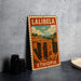 A vintage-style stamp depicting the Lalibela, a famous landmark in Ethiopia, is displayed on a table.