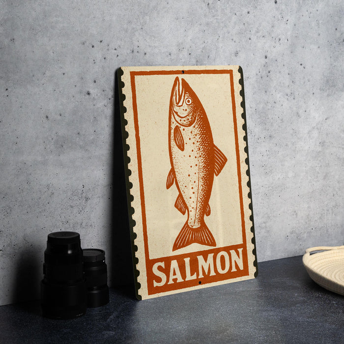 a sign with an illustration of a fish, specifically a salmon, and the word "SALMON" written on it.