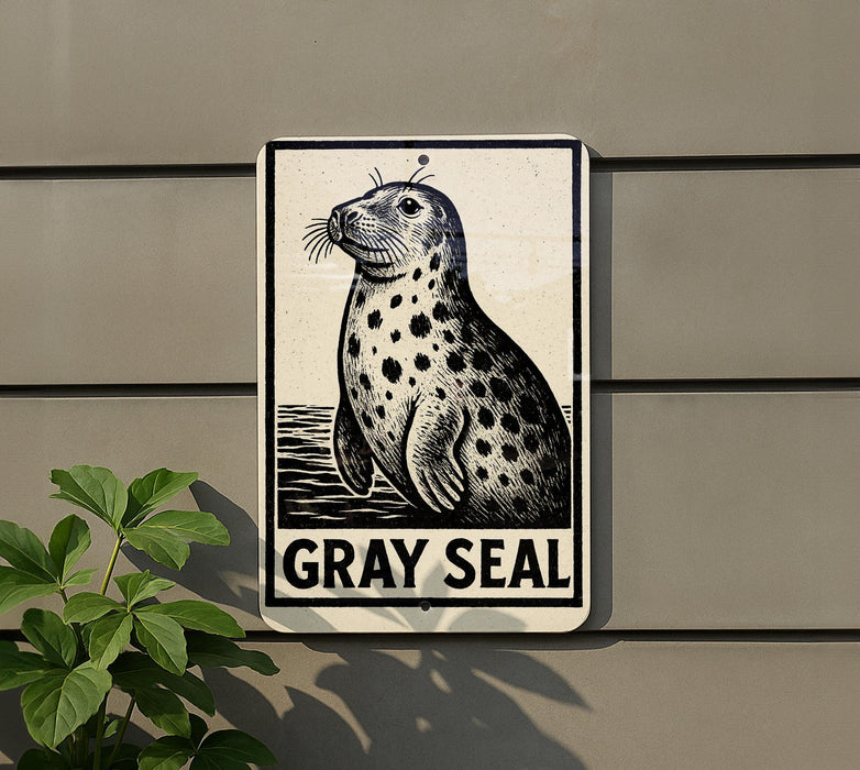 a sign with a black and white illustration of a seal, mounted on a wall.