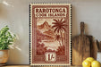 a framed print of a tropical island landscape, with a palm tree and mountains in the background, placed on a shelf next to a wooden cutting board and a potted plant.