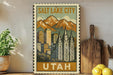 A framed vintage-style poster of Salt Lake City, Utah, featuring a mountain landscape with a city skyline in the background.