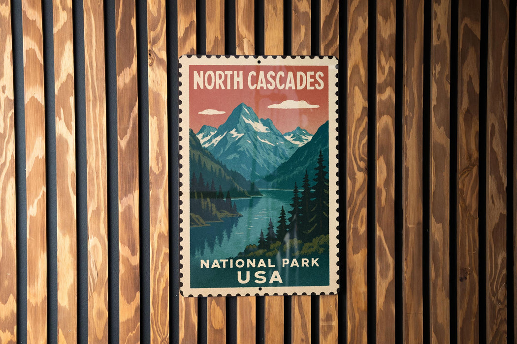 A vintage-style postage stamp depicting a scenic landscape with mountains, a river, and pine trees, mounted on a wooden wall.