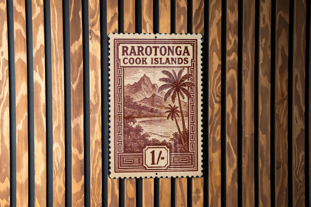 a brown and white postage stamp from the Cook Islands, with a tropical landscape and palm trees depicted on it.