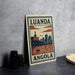 a poster or sign with the text "LUANDA ANGOLA" and an illustration of a cityscape with a river and a boat.