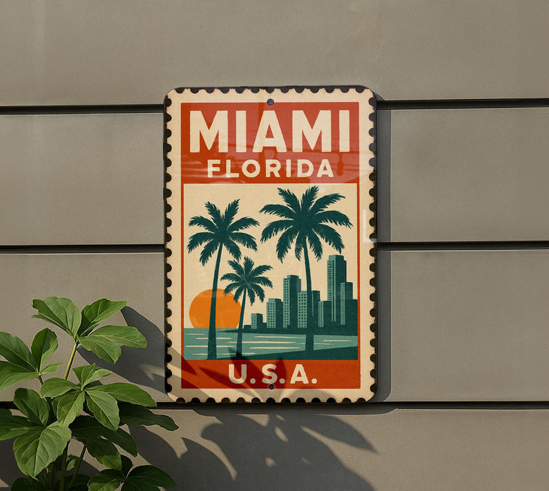A vintage-style metal sign with the text "MIAMI FLORIDA" and a graphic of palm trees and a city skyline, mounted on a wall.