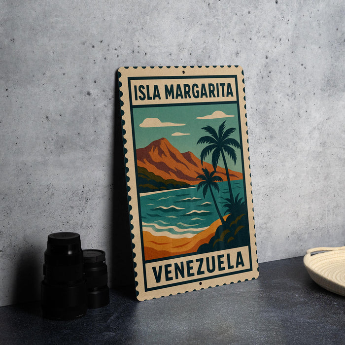 A vintage-style metal sign with the text "ISLA MARGARITA VENEZUELA" and an illustration of a tropical beach scene with palm trees and mountains.