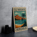 A vintage-style metal sign with the text "ISLA MARGARITA VENEZUELA" and an illustration of a tropical beach scene with palm trees and mountains.