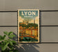 A vintage-style postage stamp depicting the city of Lyon, France, with a bridge and buildings in the background.