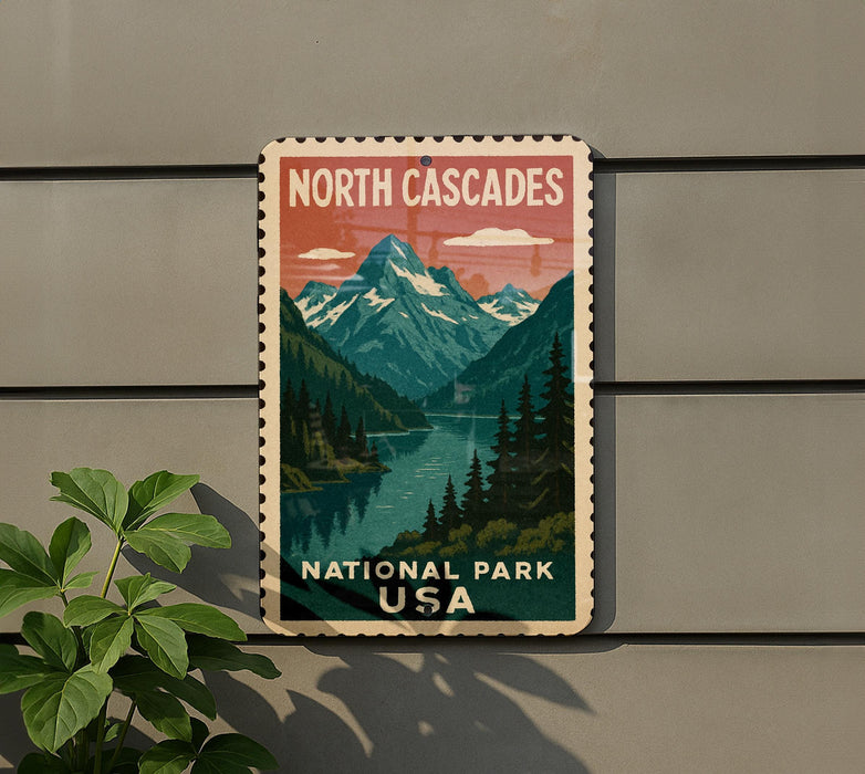 A vintage-style sign for North Cascades National Park in the United States, featuring a mountain landscape with a river and pine trees.