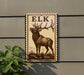 a wooden sign with a deer illustration, mounted on a wall next to a plant.