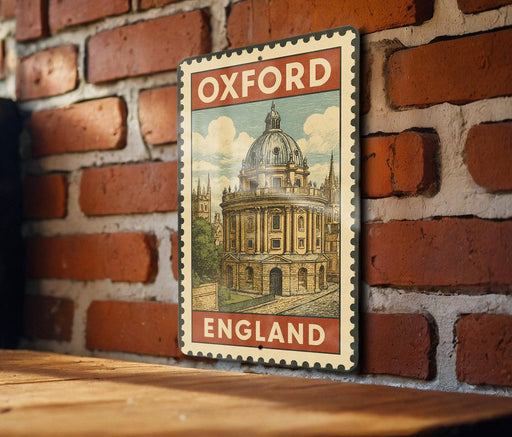 A vintage-style metal sign with the text "Oxford ENGLAND" displayed on a brick wall.