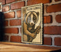 A wooden table with a wooden frame, and a framed illustration of a cute, furry animal, likely a koala, on the table.
