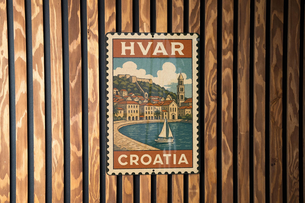 A vintage-style metal stamp depicting a coastal town in Croatia, with a sailboat on the water and buildings along the shore.