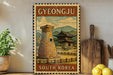 A vintage-style metal sign with a traditional Korean house and tower, surrounded by a wooden fence, is displayed on a shelf with a potted plant and a wooden cutting board.