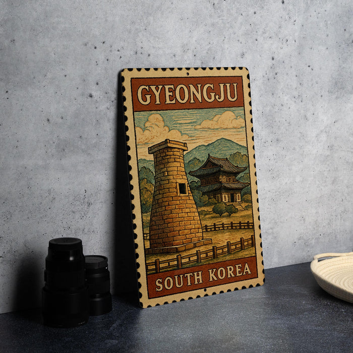 A vintage postage stamp featuring a castle and mountains, with the text "GYEONGJU SOUTH KOREA" printed on it.