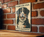 A vintage-style poster featuring a Bernese Mountain Dog, with the text "Forever USA" and "Bernese Mountain Dog" printed on it, mounted on a brick wall.