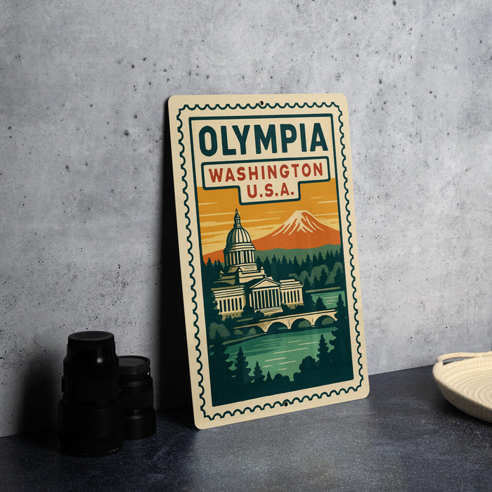 A vintage-style metal sign with the text "OLYMPIA WASHINGTON U.S.A." and an illustration of the Washington State Capitol building, with a mountain in the background.