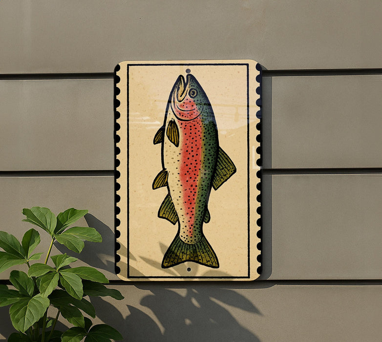 a fish painted on a wall, with a plant to the left of the fish.