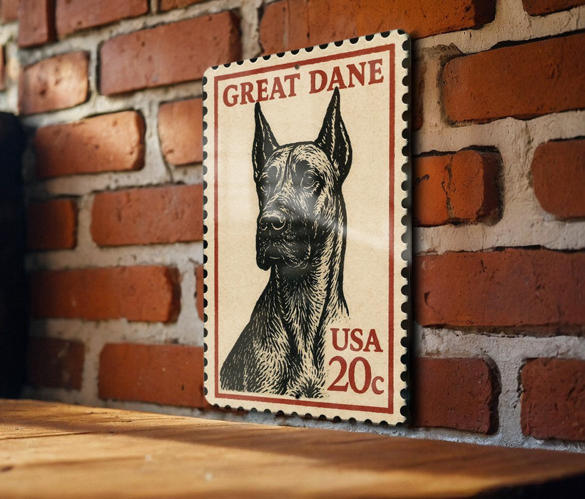 A framed postage stamp featuring a Great Dane dog, mounted on a brick wall.