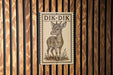 a wooden wall with a framed illustration of a deer, which is mounted on the wall.