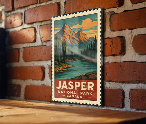 A vintage-style poster of a mountain landscape with a river, hanging on a brick wall.