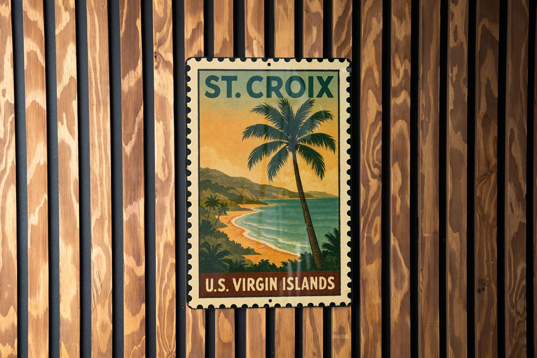 A vintage postage stamp depicting a tropical beach scene with palm trees and a sunset over the ocean, mounted on a wooden wall.