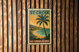 A vintage postage stamp depicting a tropical beach scene with palm trees and a sunset over the ocean, mounted on a wooden wall.