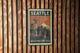 A vintage-style metal stamp depicting the Seattle skyline, with the text "SEATTLE WASHINGTON USA" prominently displayed.