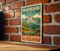 A vintage postage stamp featuring a mountain landscape with the text "DRAKENSBERG MOUNTAINS SOUTH AFRICA" is displayed on a brick wall.