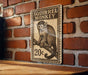 A metal sign featuring a monkey sitting on a branch, with the text "SQUIRREL MONKEY" and a price of 20 cents.