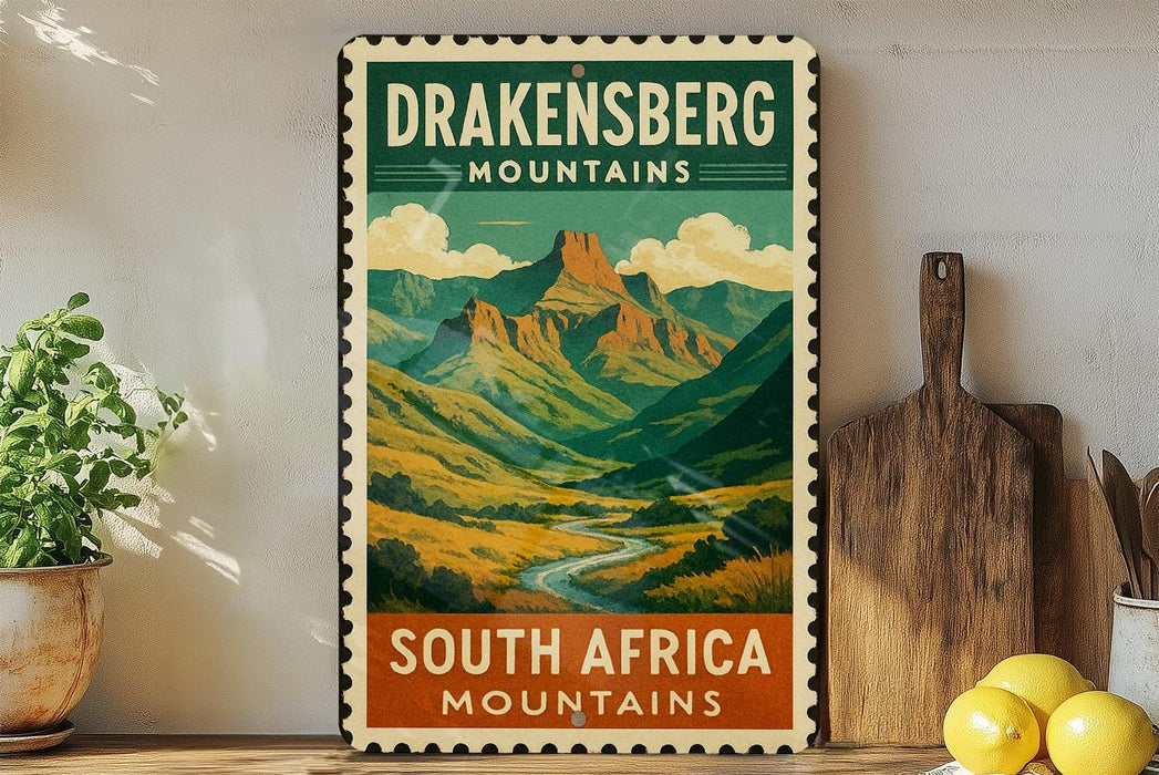 A vintage-style poster of the Drakensberg Mountains in South Africa, featuring a scenic mountain landscape with a winding river.
