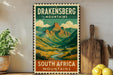A vintage-style poster of the Drakensberg Mountains in South Africa, featuring a scenic mountain landscape with a winding river.