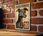 a wooden table with a framed illustration of an Italian Greyhound dog on it, mounted on a brick wall.