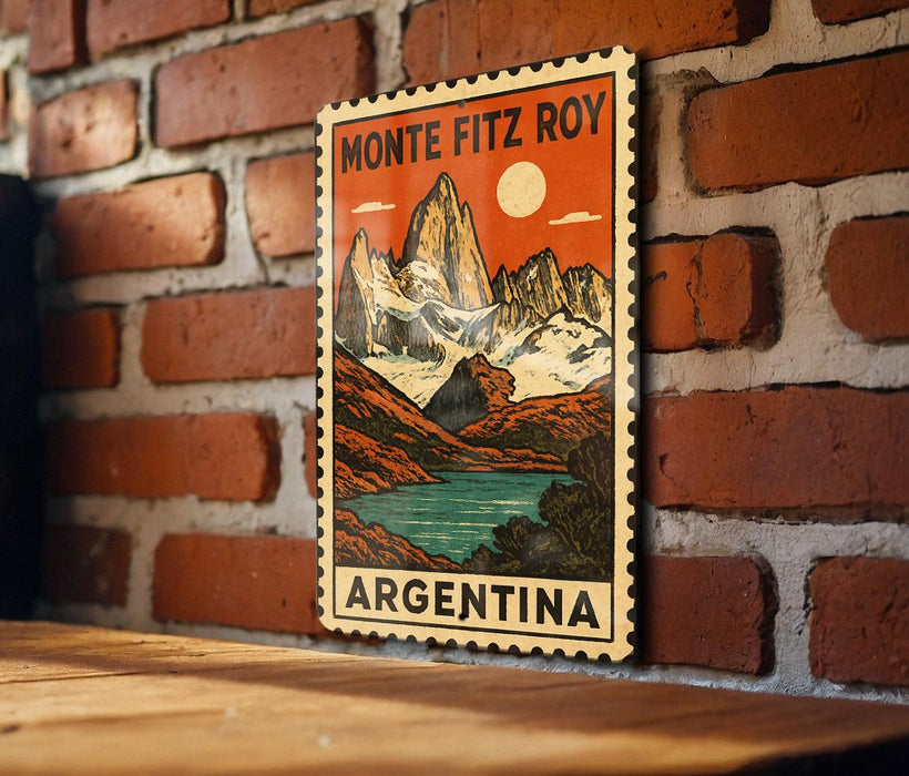 A vintage-style poster of the Monte Fitz Roy mountain range in Argentina, featuring a scenic landscape with a lake and mountains.