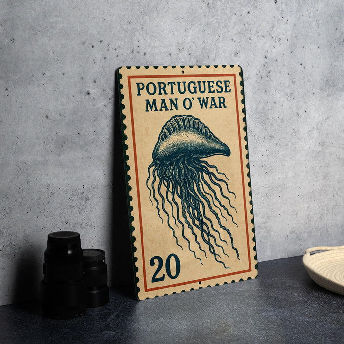 a vintage-style Portuguese postage stamp with an illustration of a jellyfish, placed on a table next to some black camera lenses.