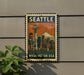 A vintage-style metal sign with the word "SEATTLE" and an illustration of the Space Needle, mounted on a wall.