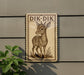 a sign with a deer illustration on it, mounted on a wall next to a plant.