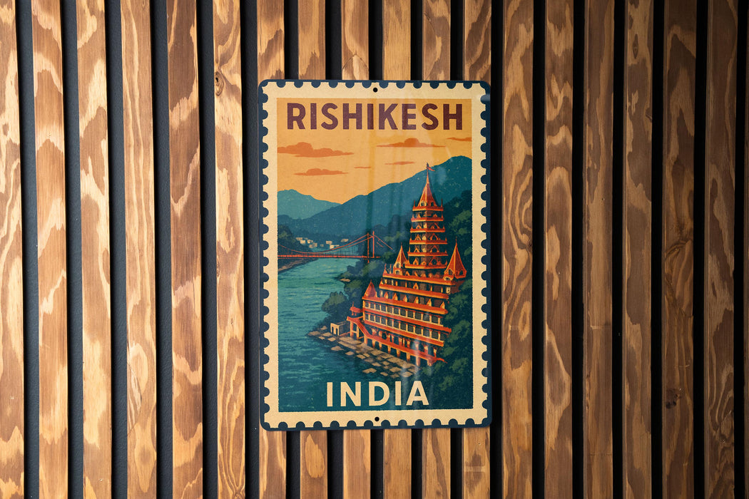 A vintage-style metal sign with the text "RISHIKESH" and "INDIA" printed on it, hanging on a wooden wall.