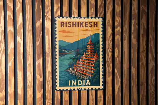 A vintage-style metal sign with the text "RISHIKESH" and "INDIA" printed on it, hanging on a wooden wall.