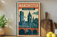 A vintage-style poster of Manchester, England, featuring a cityscape with a clock tower and a bridge, displayed on a wall next to a wooden cutting board and some potted plants.