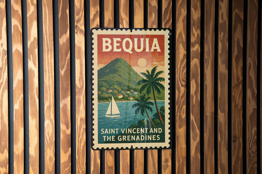 A vintage-style poster of Saint Vincent and the Grenadines, featuring a sailboat on the water and palm trees, is displayed on a wooden wall.