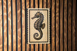 a seahorse on a wooden wall.