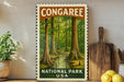 A framed poster of a forest scene with the text "CONGAREE NATIONAL PARK USA" displayed prominently.