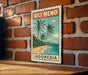 A vintage postage stamp featuring a tropical beach scene with palm trees and a blue sky, hanging on a brick wall.