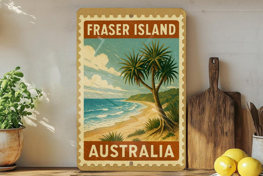 A framed vintage-style stamp depicting a tropical beach scene with palm trees and the ocean, placed on a shelf next to a wooden cutting board and some lemons.