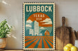 A vintage-style poster of Lubbock, Texas, USA, featuring a cityscape with buildings, a barn, and a field with a sunburst pattern.