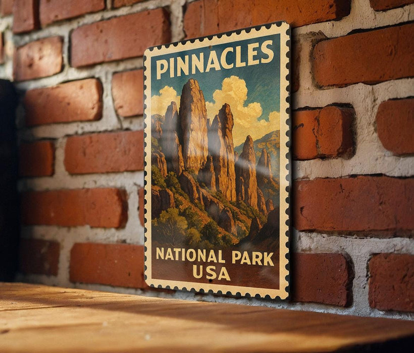 A vintage-style poster of Pinnacles National Park in the USA, featuring a scenic mountain landscape with towering rock formations.